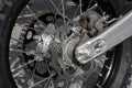 Closeup of a motorcycle rear wheel, tire, disc brake, sprocket and chain assembly Royalty Free Stock Photo