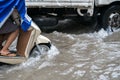 Closeup motorcyclist rides along a flooded street in Hanoi city, Vietnam