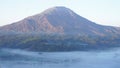 Closeup of Mount Batur morning view with fog from Pinggan Village or Desa Pinggan in Indonesia with fog.