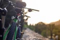 Closeup of mountain bikes standing leaned on a wall. Multiple bikes, later afternoon sunset golden hour. Friends resting their Royalty Free Stock Photo