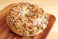 Mouthwatering pumpkin seed and sesame bun on a wooden breadboard Royalty Free Stock Photo