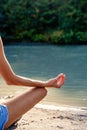Closeup of mudra gesture of young woman practicing yoga outdoors on sandy beach meditating and enjoying the silence Royalty Free Stock Photo