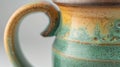 A closeup of the mugs handle showing off its seamless attachment to the body of the mug a testament to the potters skill