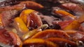 Closeup of mulled wine thar stiring wooden spoon, slow motion