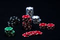 Closeup of multi-colored stacks of poker chips in the black background