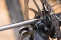 Closeup multi screwdriver working on mechanical parts next to wheel spokes