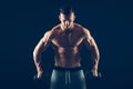 Closeup of a muscular young man lifting dumbbells Royalty Free Stock Photo