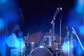 Closeup of a musical drum set on a stage with a beautiful bokeh.