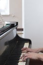 Closeup musician hands playing piano on piano keyboard