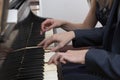 Closeup musician hands playing piano on piano keyboard