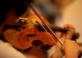 Closeup of the musician`s hand is playing a violin in an orchestra