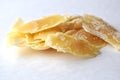 A closeup of a natural beeswax shavings for cosmetic use and candlemaking on white Royalty Free Stock Photo