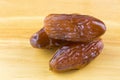 Closeup of natural dried dates fruit on wooden background