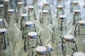 A closeup of the neck of a bottle. Group of empty bottles with plastic caps in a store on the counter.