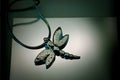 Closeup of a necklace in shape of a silver dragonfly