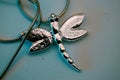 Closeup of a necklace in shape of a silver dragonfly