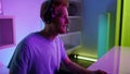 Closeup neon hands using gaming equipment at home. Esport professional lifestyle