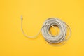 Closeup RJ45 Network internet cable hank on a yellow background. Concept, flat lay Royalty Free Stock Photo