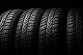 Closeup new car tires for sale at tyre store. Balck rubber car tire with modern tread at auto repair shop. Winter tires at auto