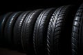 Closeup new car tires for sale at tyre store. Balck rubber car tire with modern tread at auto repair shop. Winter tires at auto