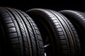 Closeup new car tires for sale at tyre store. Balck rubber car tire with modern tread at auto repair shop. Winter tires at auto Royalty Free Stock Photo