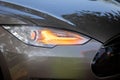 Closeup of new projector headlight on the modern gray car Royalty Free Stock Photo