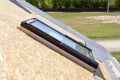 Closeup of new skylight mansard window on a roof under construction. Royalty Free Stock Photo