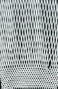 Textureof white packaging synthetic mesh on black background. Nylon white macro texture pattern background. Royalty Free Stock Photo