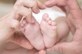 Closeup of newborn baby feet. Baby feet in mother hands. Family hearth shape. Love and care. Mom and dad love. Royalty Free Stock Photo