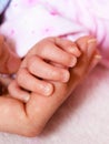 Closeup newborn baby holding his mothers finger Royalty Free Stock Photo