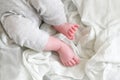 Closeup of newborn legs on a white blanket, childhood and maternity concept. Baby feet Royalty Free Stock Photo