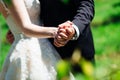 Closeup of newlyweds hands reach out while they dance
