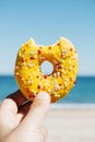 Man with a nibbled donut in his hand