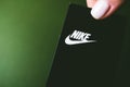 Closeup of Nike logo label on green background.