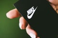 Closeup of Nike logo label on green background.