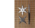 Ninja Star Shurikens with throwing spikes on Wooden Background,