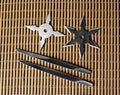 Ninja Star Shurikens with throwing spikes on Wooden Background