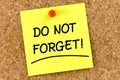 Closeup note on corkboard with do not forget message on it