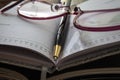 Closeup of notebook, pen and glasses. Royalty Free Stock Photo