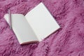 Closeup of notebook,pen on pink modern fluffy plaid.Blank sheets.Women style