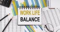 Closeup a notebook with text WORK LIFE BALANCE , business concept image on chart background Royalty Free Stock Photo