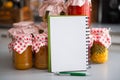 Closeup on notepad among jars in kitchen Royalty Free Stock Photo