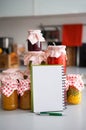 Closeup on notepad among jars in kitchen Royalty Free Stock Photo