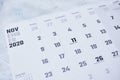 Closeup of a November 2020 calendar focusing on Veterans Day, on a white textured surface Royalty Free Stock Photo