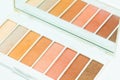 A closeup of nude eyeshodows and a mirror. Royalty Free Stock Photo