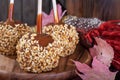 Closeup of Nutty Caramel Apple on a Rustic Background Royalty Free Stock Photo