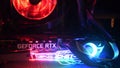 Closeup NVidia GeForce RTX 3080 inside gaming PC tower with colorful backlights in darkness