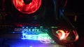 Closeup NVidia GeForce RTX 3080 inside gaming PC tower with colorful backlights in darkness