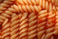 Closeup ohoto of a group of noodles in spaghetti sauce.