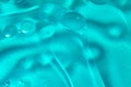 Closeup of oil spots in clean  water and bubbles colored in green abstract beautiful background Royalty Free Stock Photo